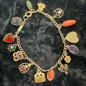 Vintage charm Bracelet in 14k with 15 beautiful Charms.  Weighs over 1/2 oz.